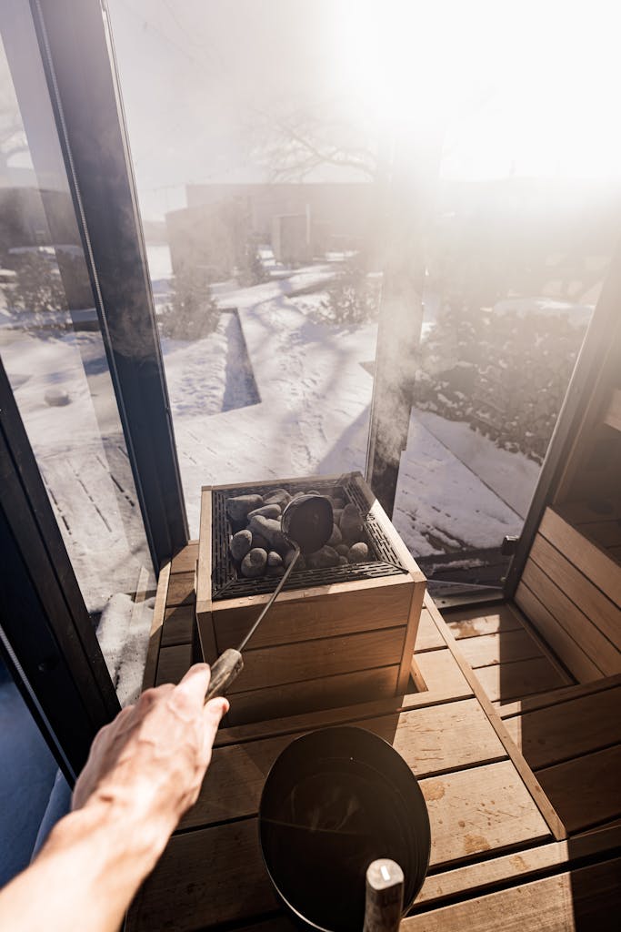 A beautifully designed sauna with a view of snowy outdoors, showcasing modern sauna elements and Nordic design.